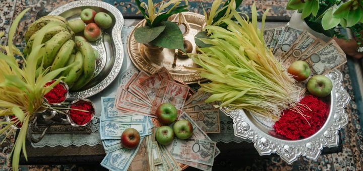 A table with money, fruit and other items
