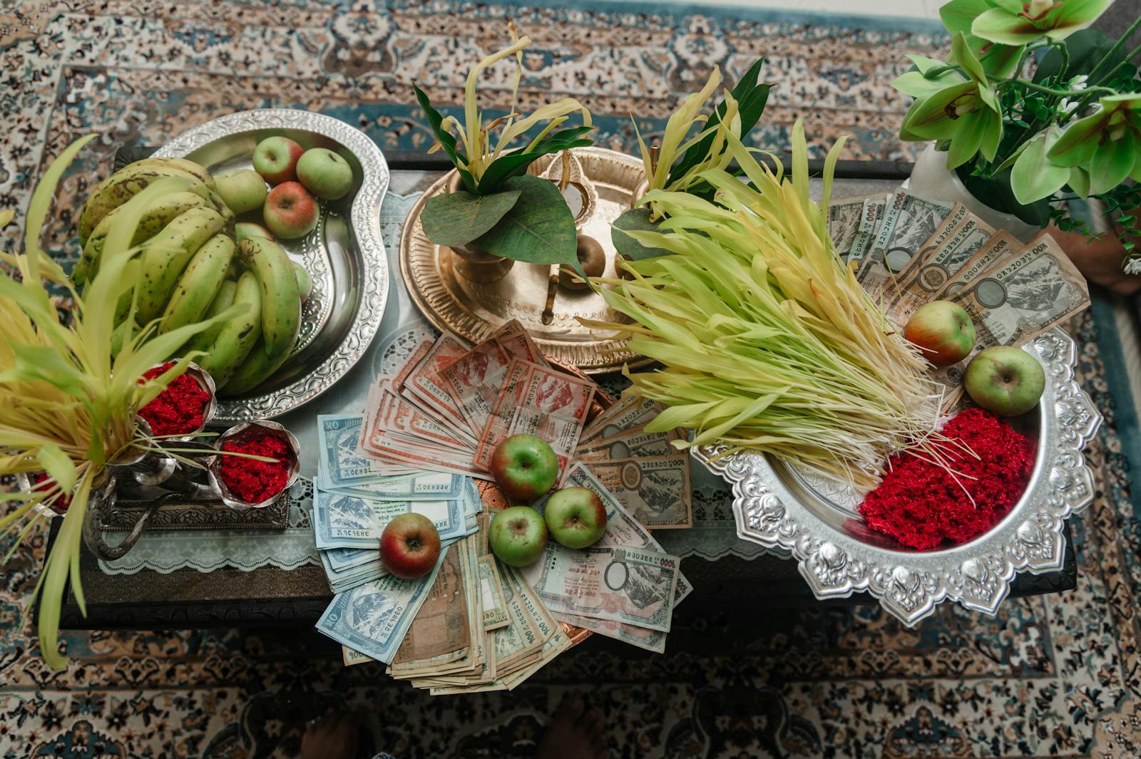 A table with money, fruit and other items