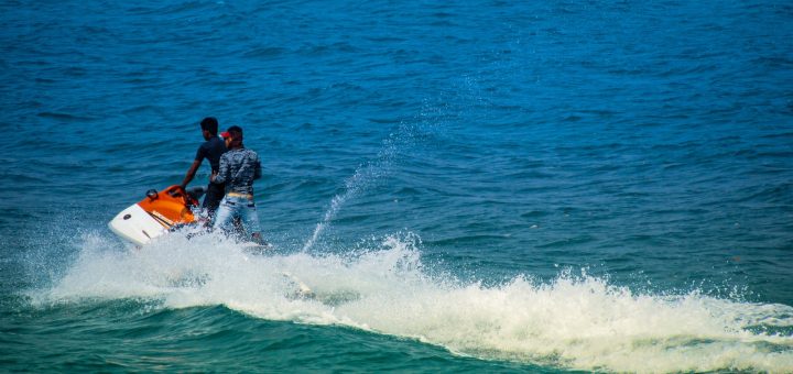 2 men surfing on sea during daytime