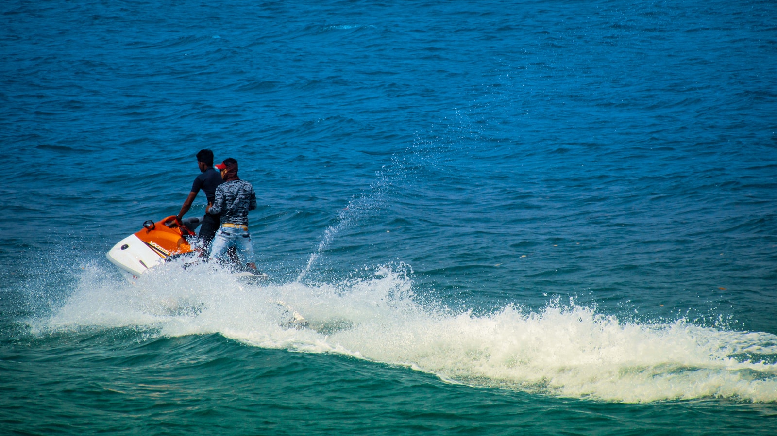 2 men surfing on sea during daytime